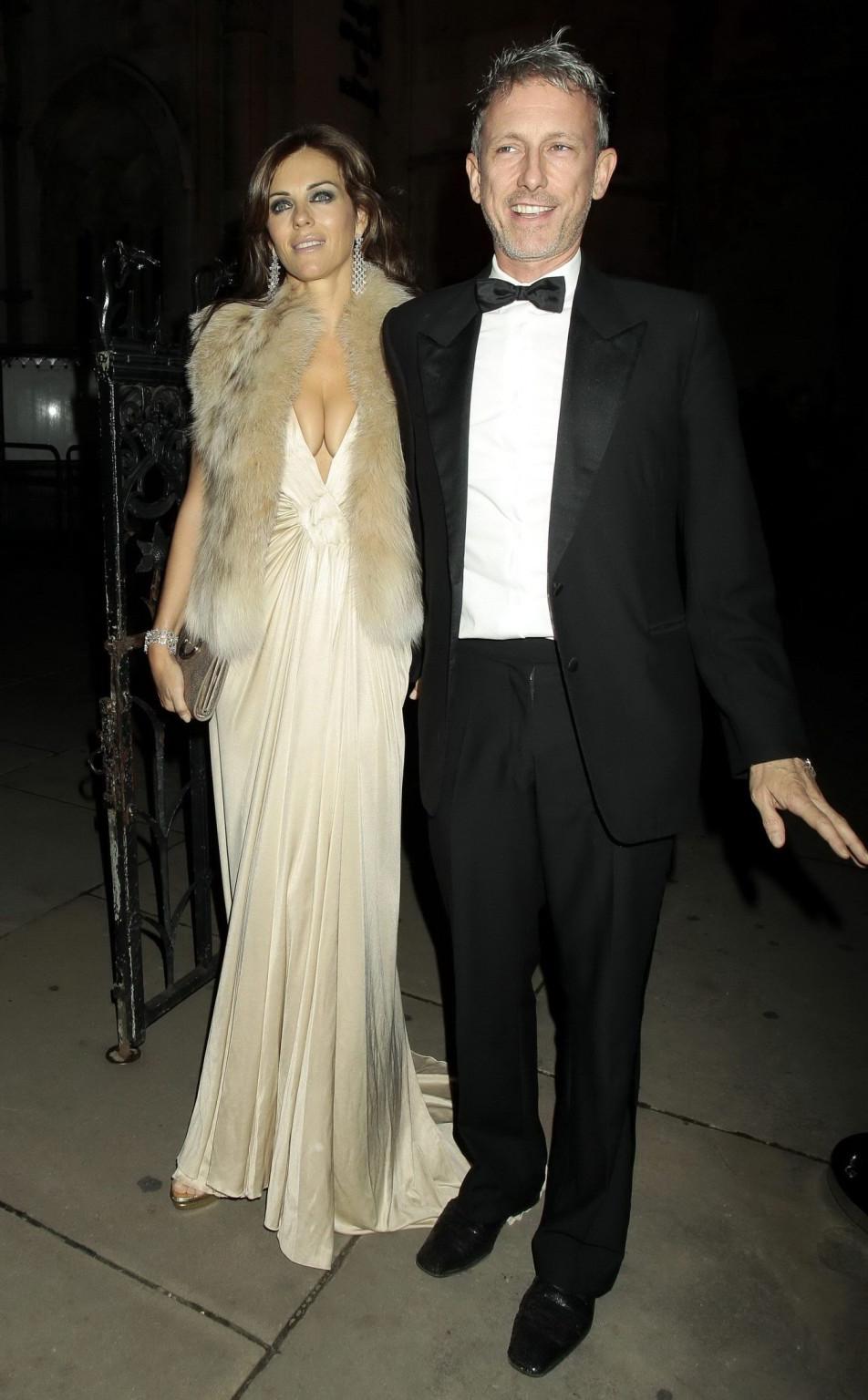 16P Elizabeth Hurley showing massive cleavage heading to Elton John's private party 