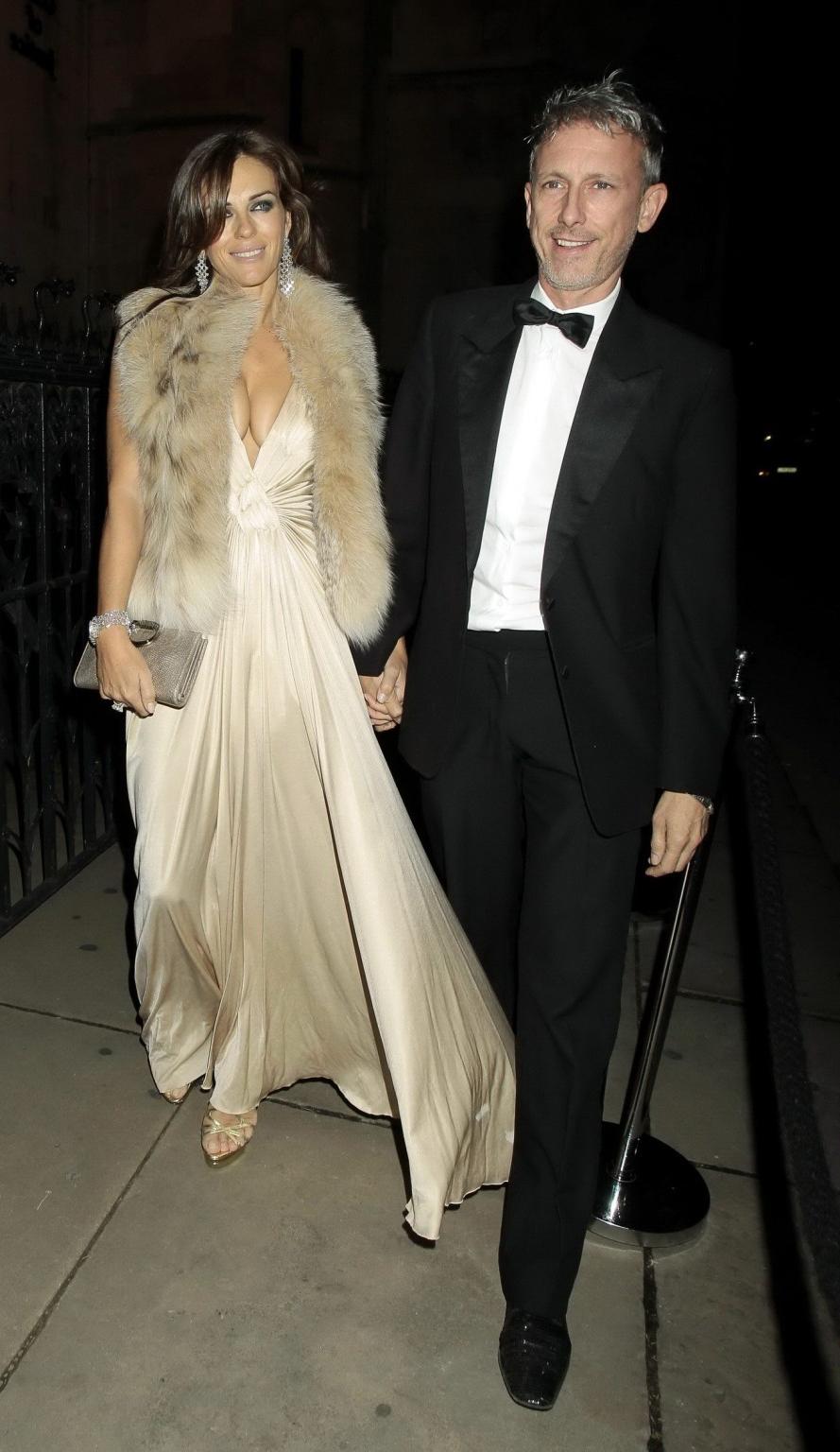 16P Elizabeth Hurley showing massive cleavage heading to Elton John's private party 