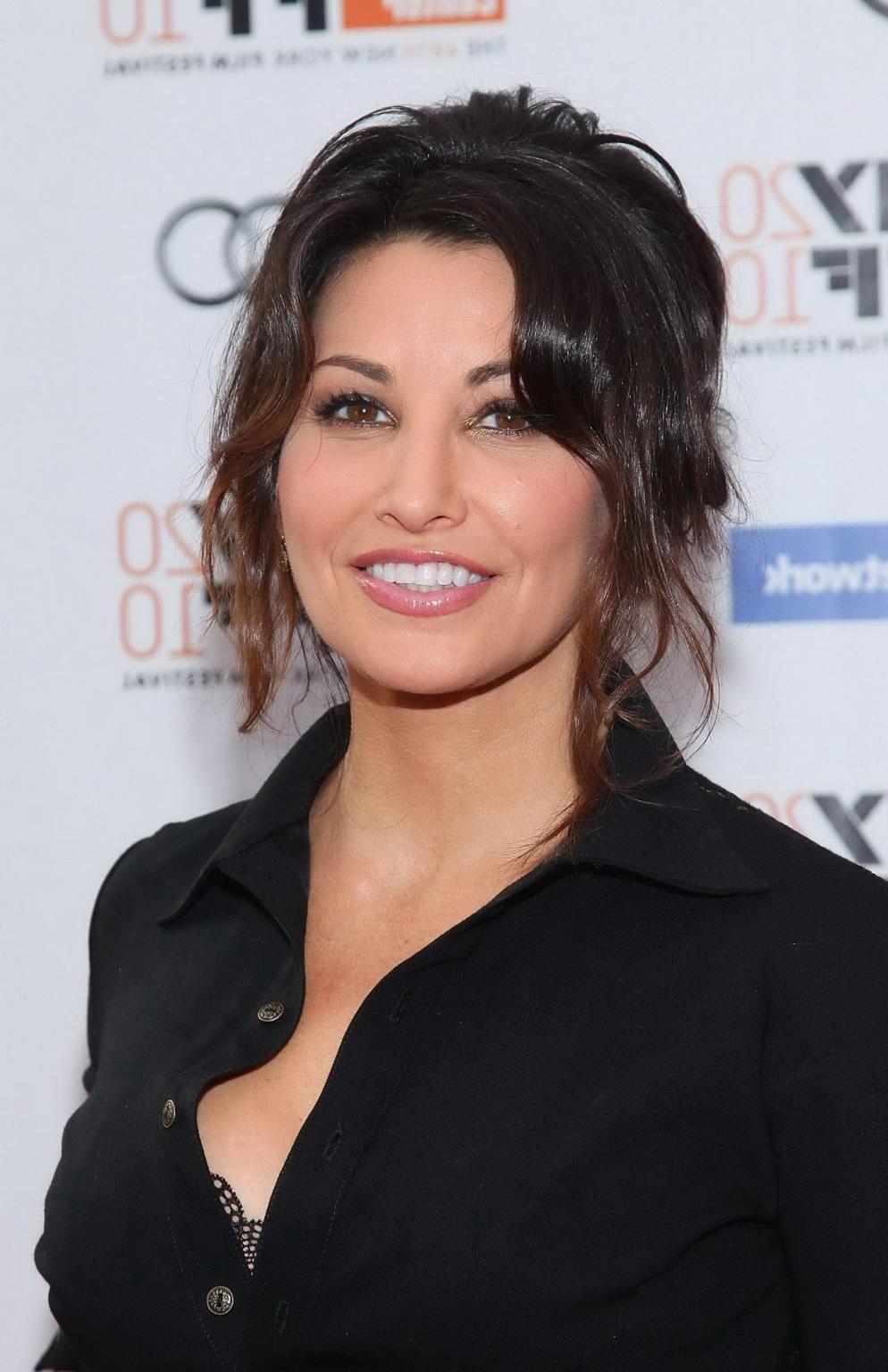 8P Gina Gershon showing nice cleavage in black shirt at 'The Social Network' premie