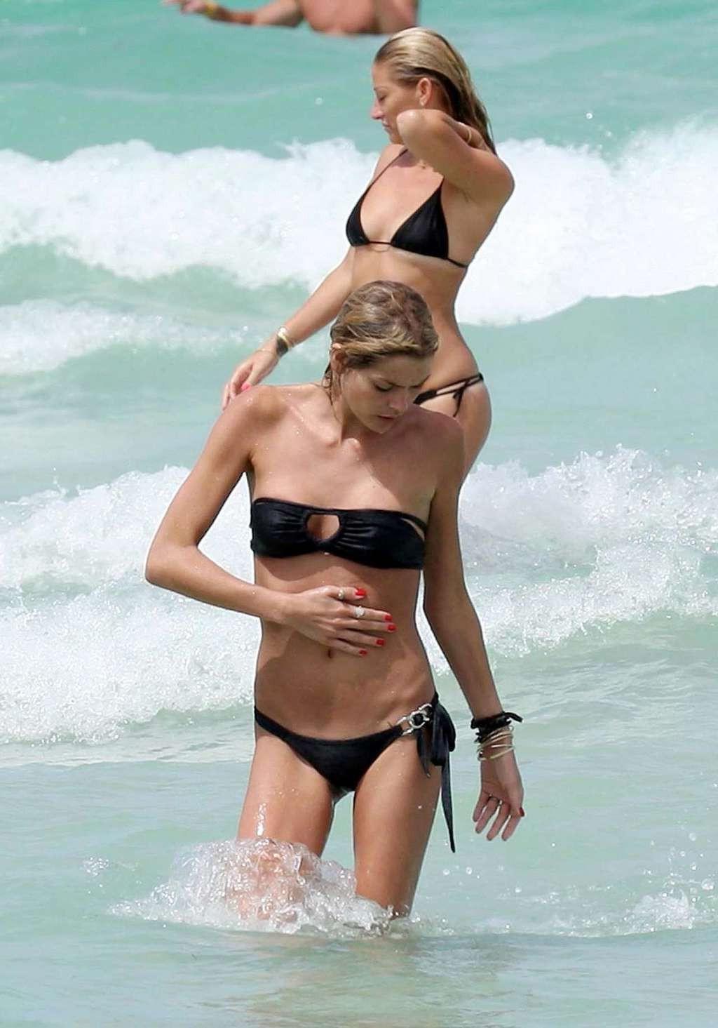 10P May Andersen tits slip from top and posing sexy in skimpy black bikini paparazzi