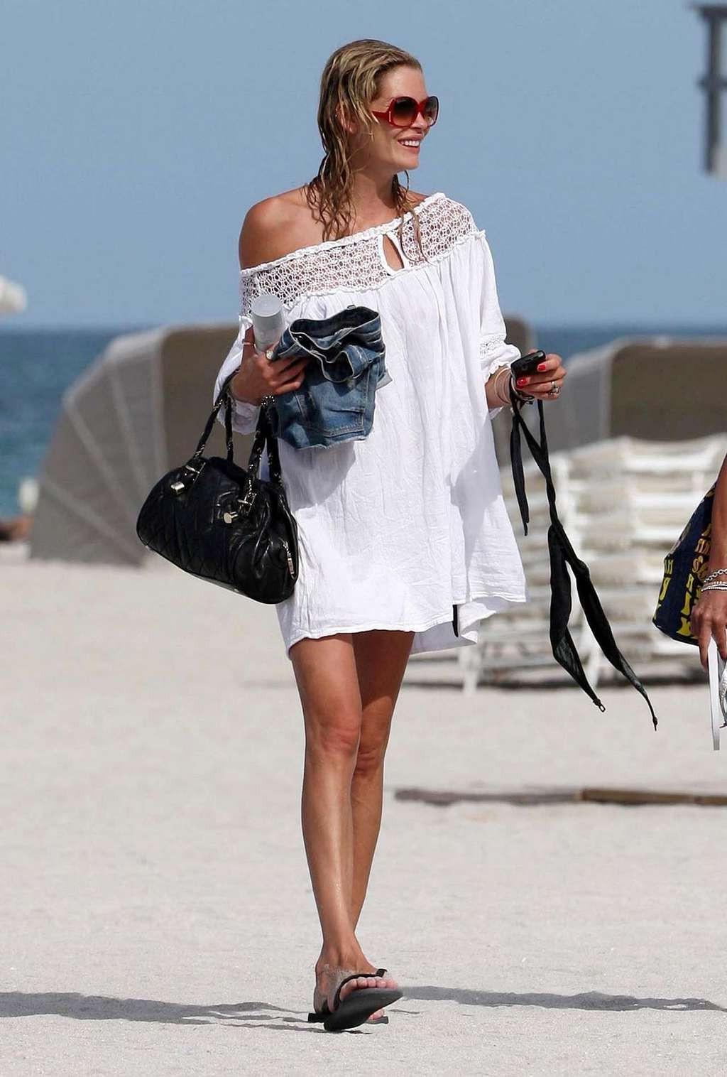10P May Andersen tits slip from top and posing sexy in skimpy black bikini paparazzi
