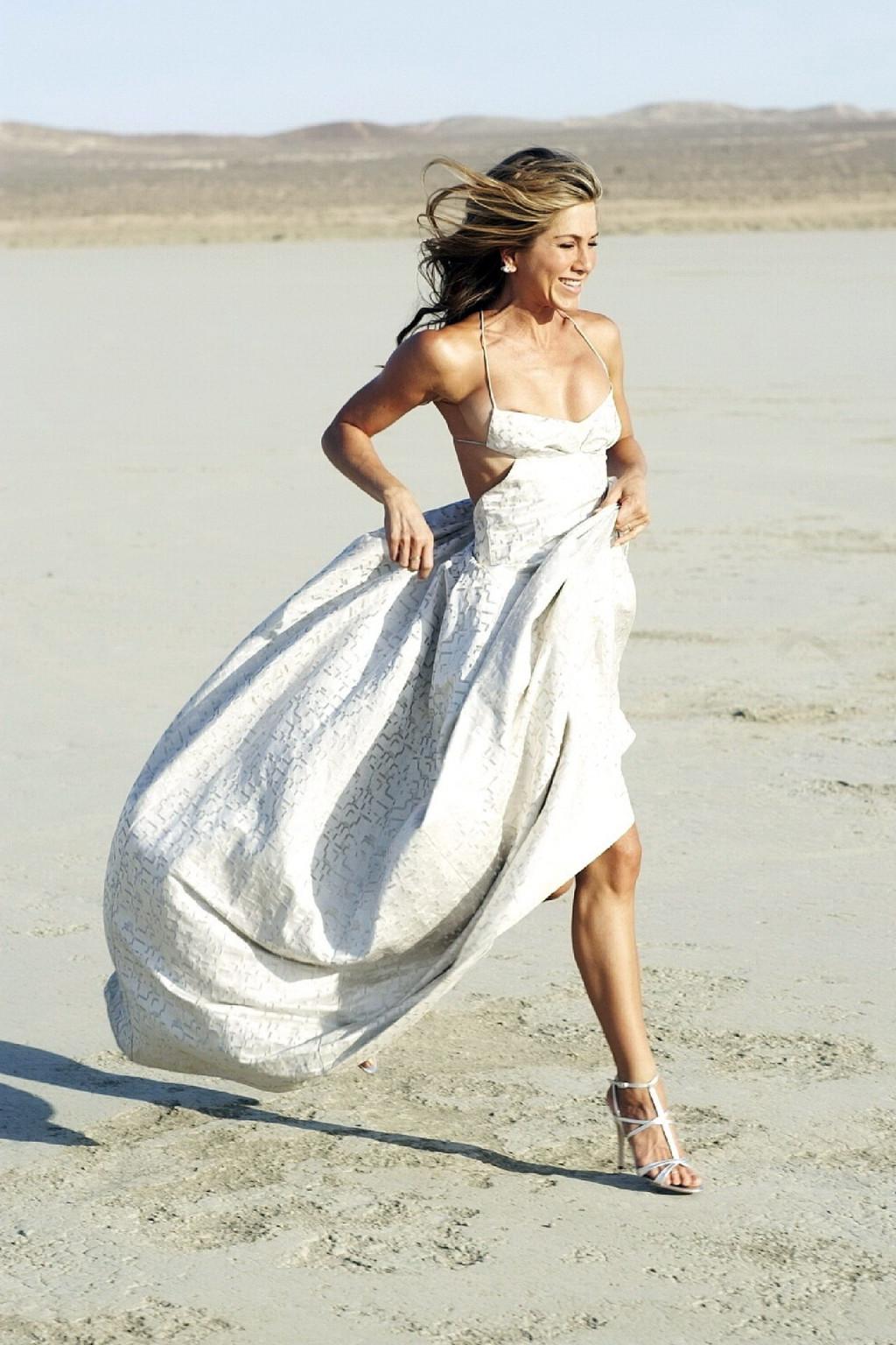 15P Jennifer Aniston almost nip slip at the 'Harper's Bazaar' beach photoshoot