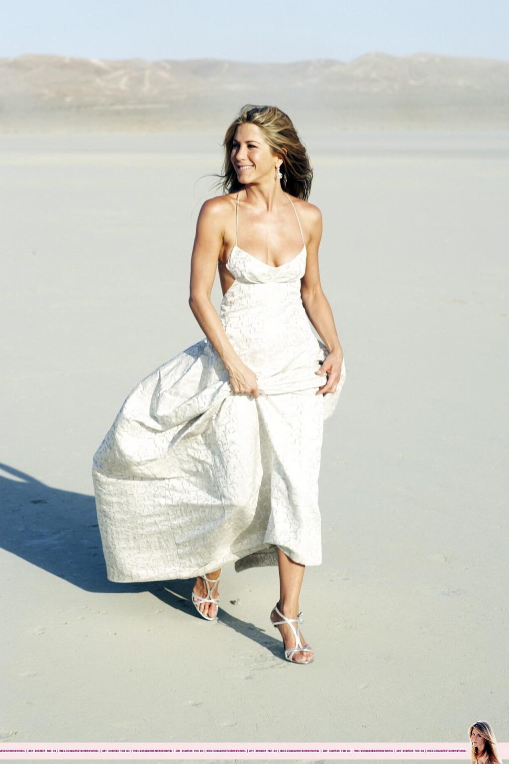 15P Jennifer Aniston almost nip slip at the 'Harper's Bazaar' beach photoshoot