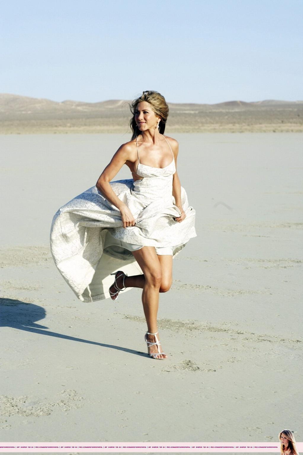 15P Jennifer Aniston almost nip slip at the 'Harper's Bazaar' beach photoshoot
