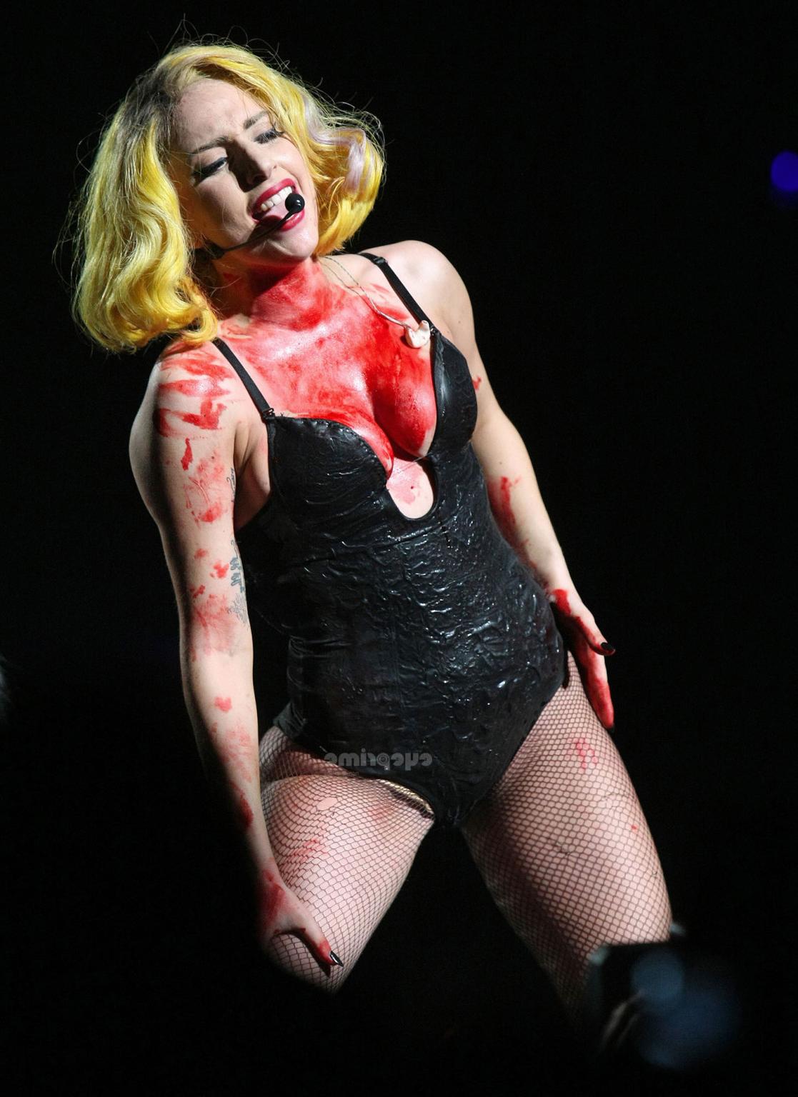 16P Lady Gaga as Vampirella in lingerie showing bloody cleavage on stage