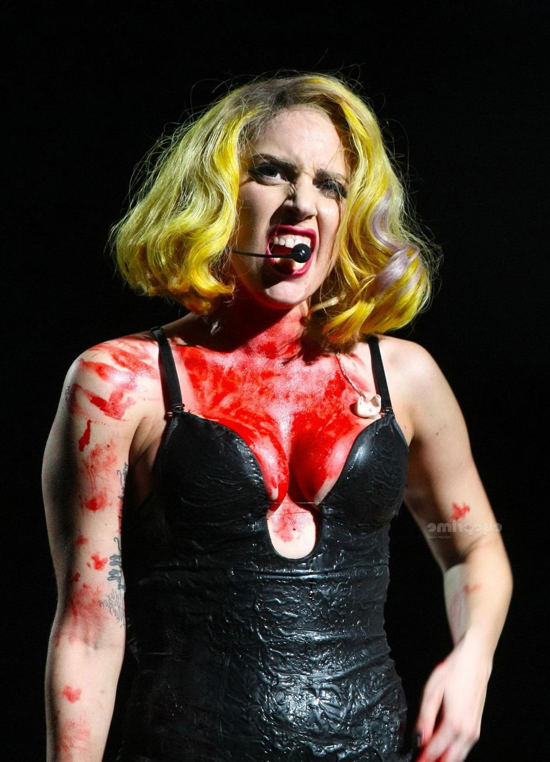 16P Lady Gaga as Vampirella in lingerie showing bloody cleavage on stage