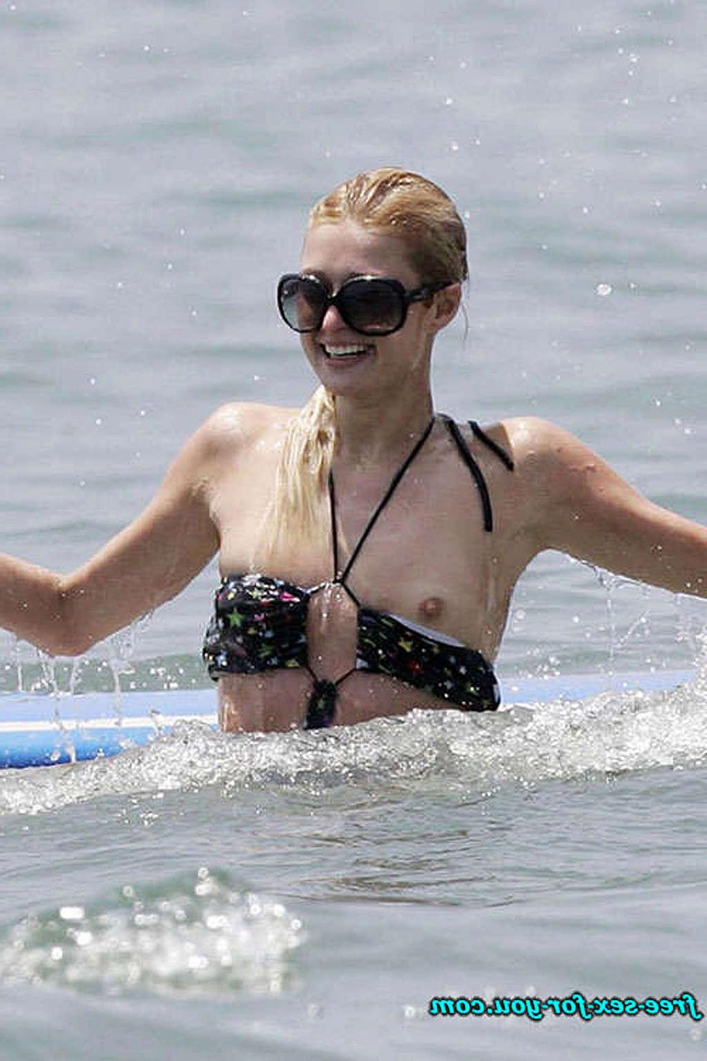 10P Paris Hilton nipple slip oops situation while parting and flashing her nice puss