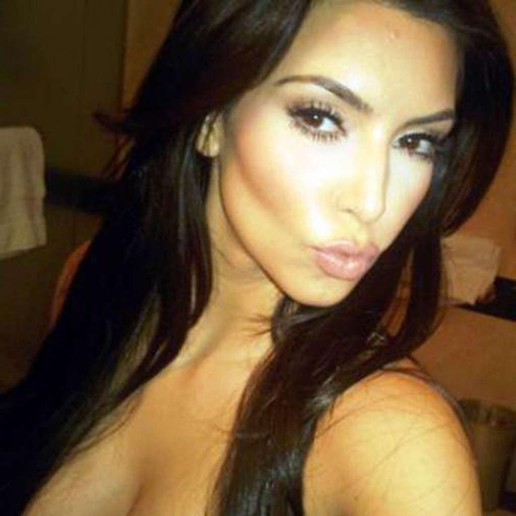 10P Kim Kardashian showing big cleavage in bikini by the pool and her big tits