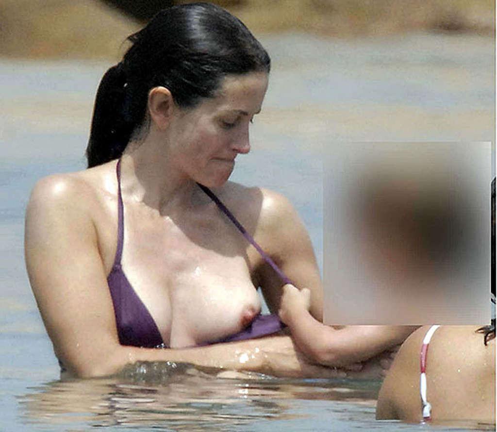 16P Courteney Cox very leggy in mini skirt and tits slip in water