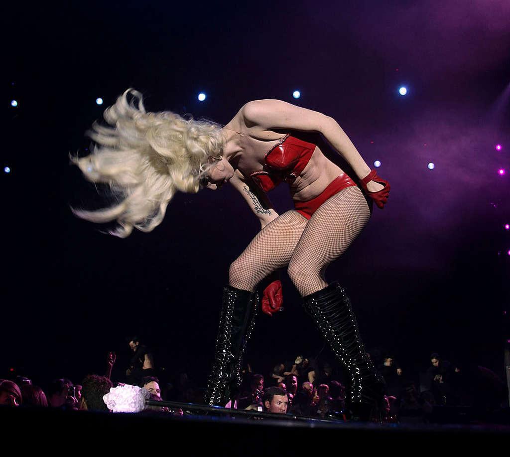 10P Lady Gaga looking very sexy in red lingerie and stockings on stage and exposing 
