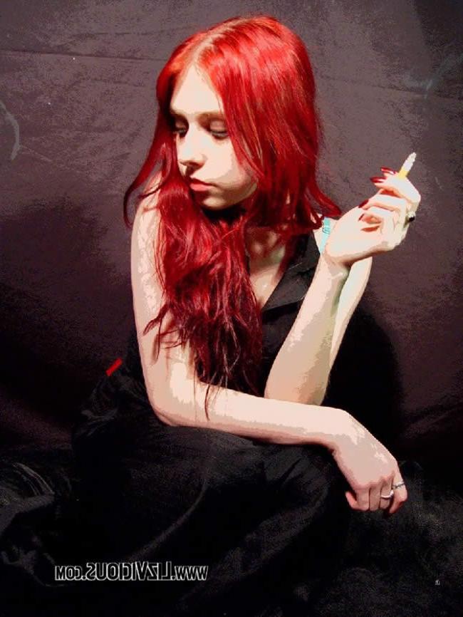 16P Smoking goth chick poses under a weird green light