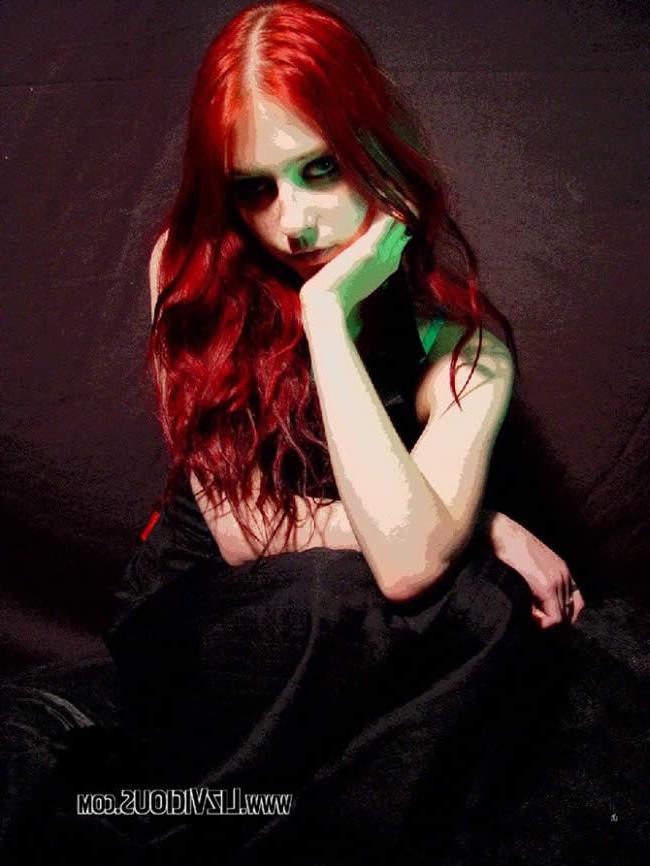 16P Smoking goth chick poses under a weird green light