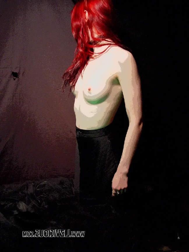 16P Smoking goth chick poses under a weird green light