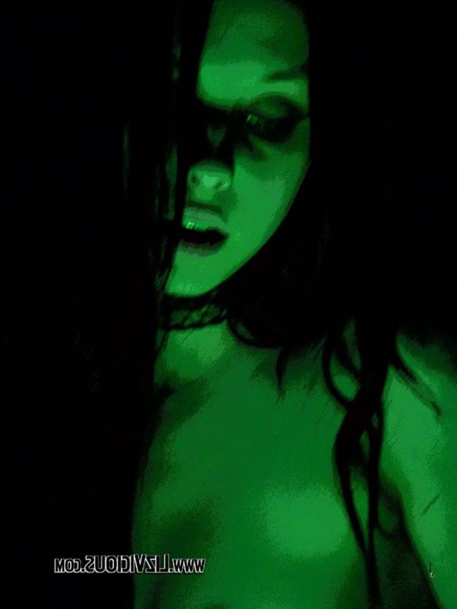 16P Smoking goth chick poses under a weird green light