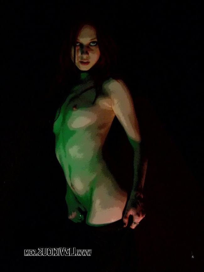 16P Smoking goth chick poses under a weird green light