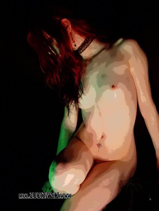 16P Smoking goth chick poses under a weird green light