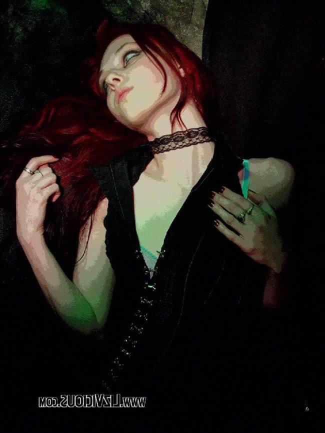 16P Smoking goth chick poses under a weird green light