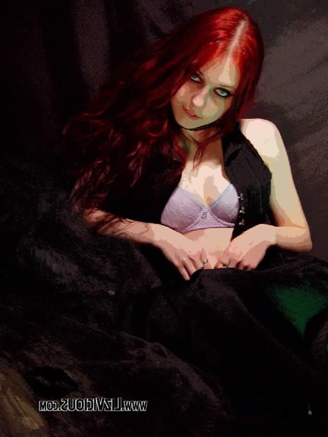 16P Smoking goth chick poses under a weird green light