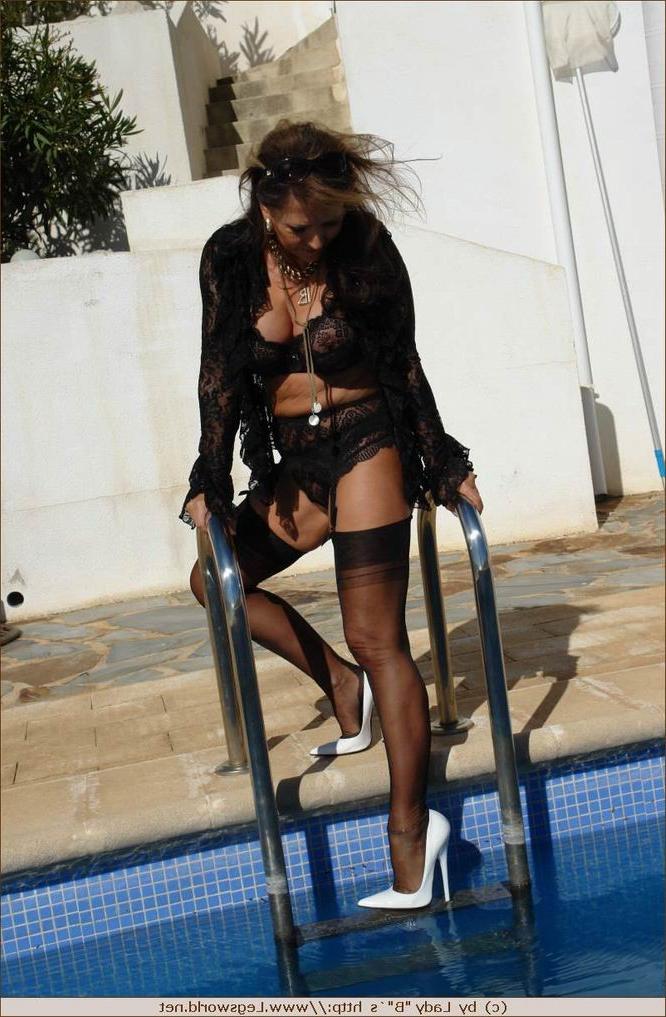 12P Leggy lady in stockings posing outdoors
