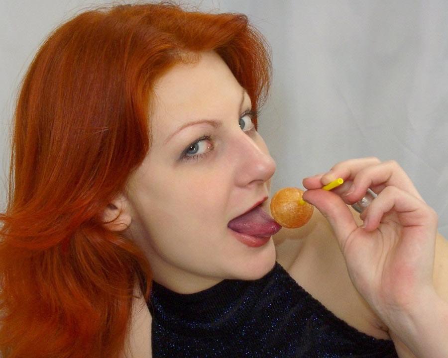 17P A sexy redhead licks a lollypop and gets naked
