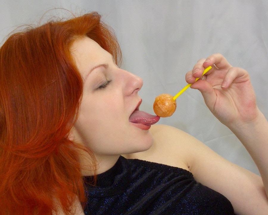 17P A sexy redhead licks a lollypop and gets naked