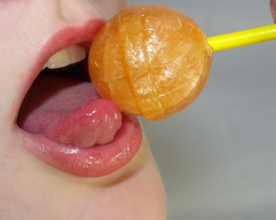 17P A sexy redhead licks a lollypop and gets naked