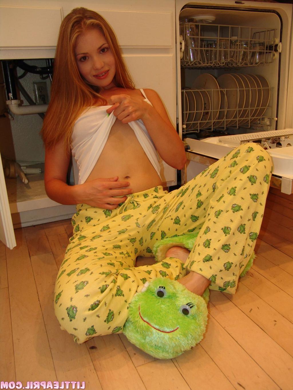 16P A teen in a kitchen shows her young round butt