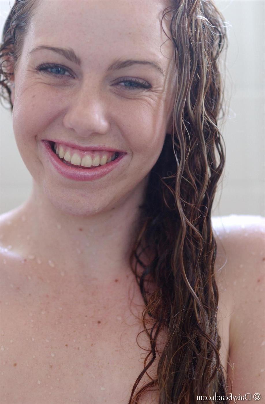 15P Amateur girl with a shaved pussy and nice tits takes a shower