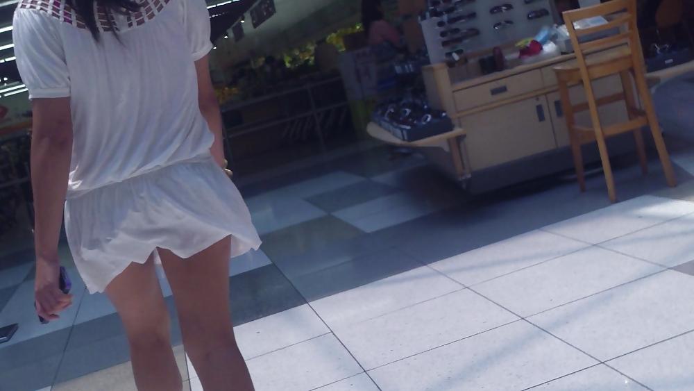 25P Cute girls ass & butt in short white mini skirt & red shoes