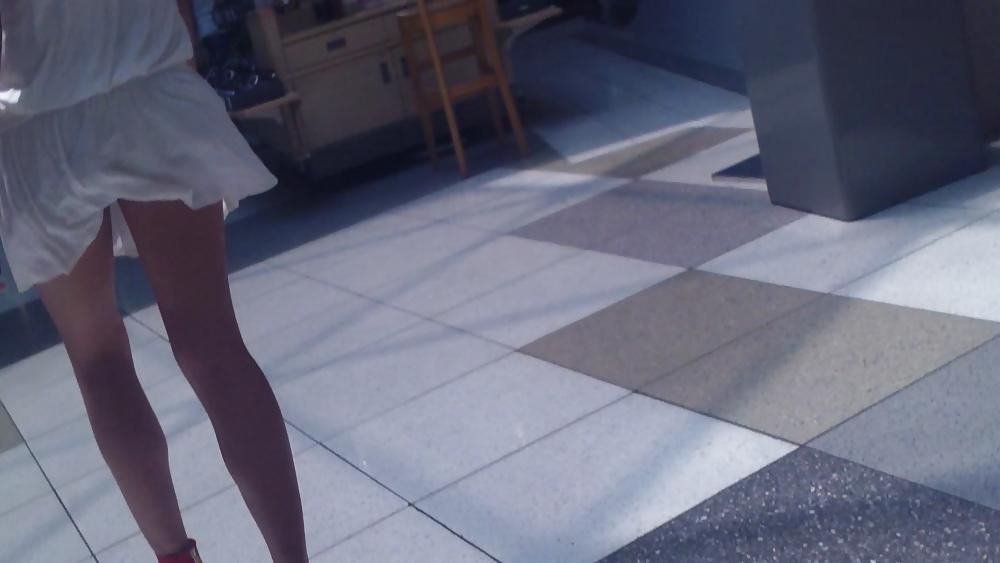 25P Cute girls ass & butt in short white mini skirt & red shoes