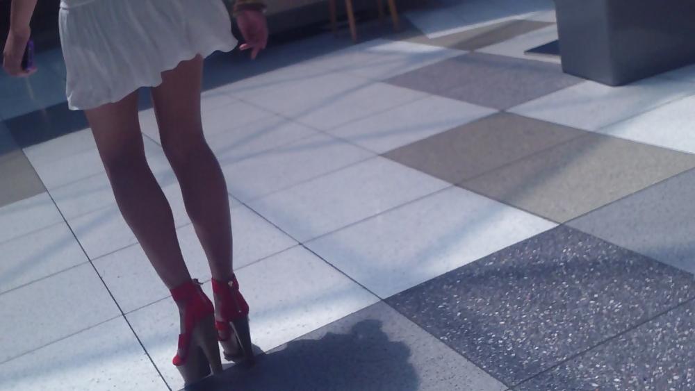 25P Cute girls ass & butt in short white mini skirt & red shoes