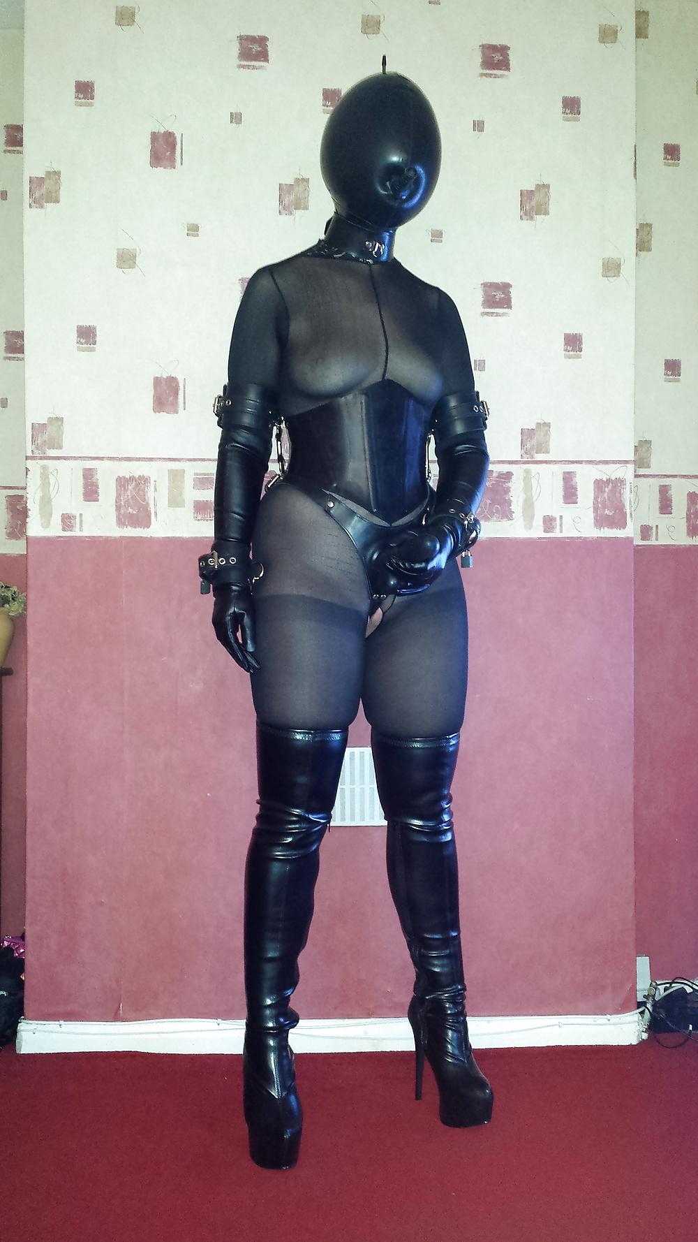 7P Strapon wearing slave girl in a rubber inflatable hood