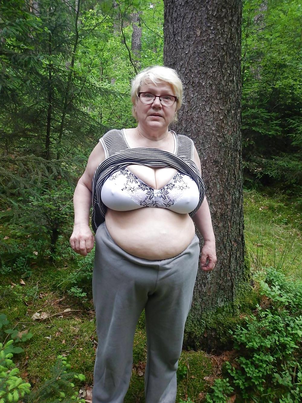 23P Busty granny in forest