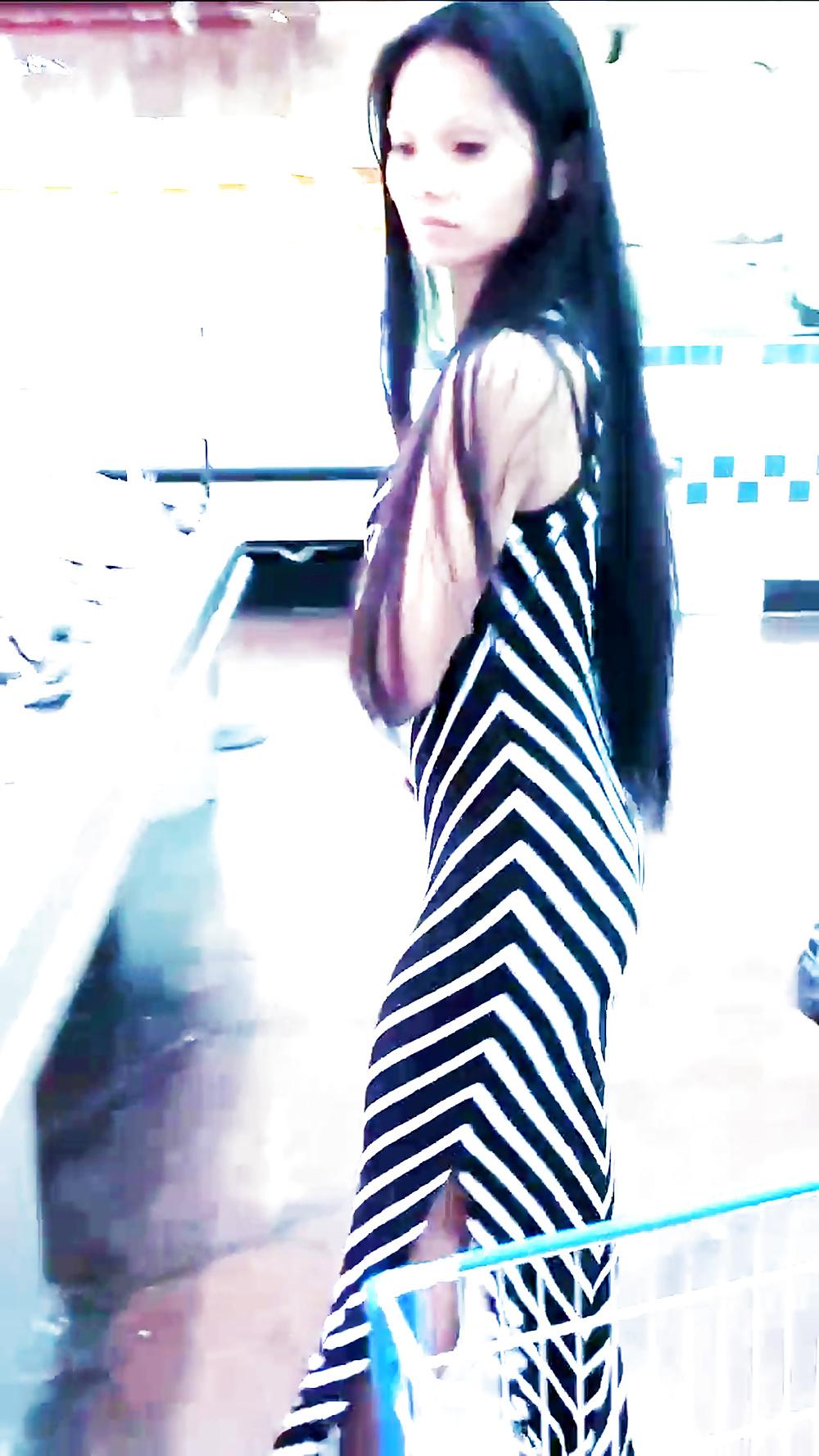 12P Sexy filipino babe in long striped skirt shopping for meat