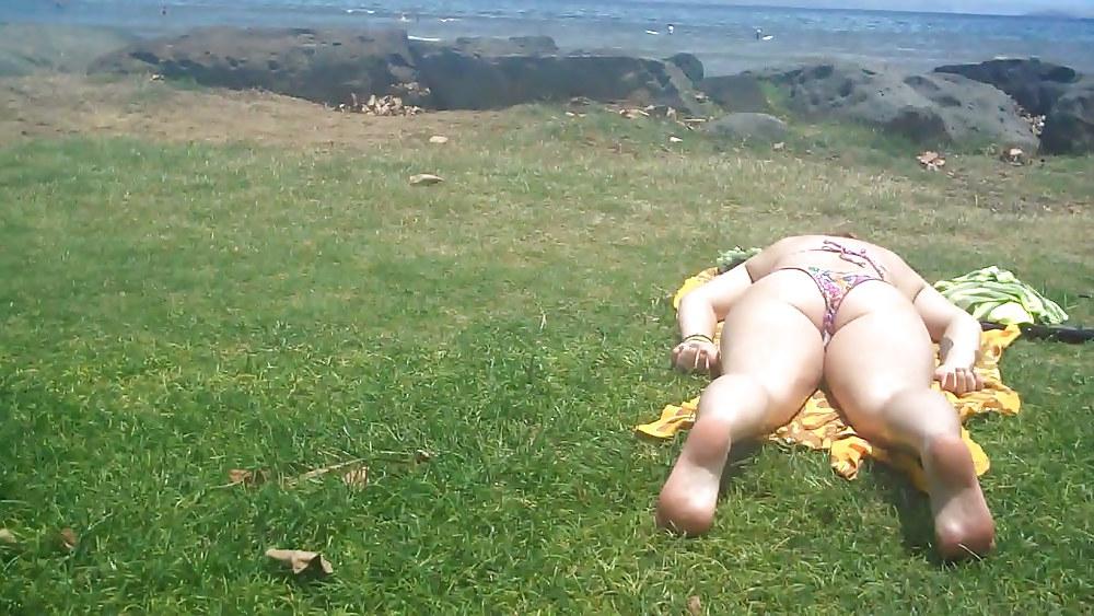 9P Laying with her ass & butt in a field of grass