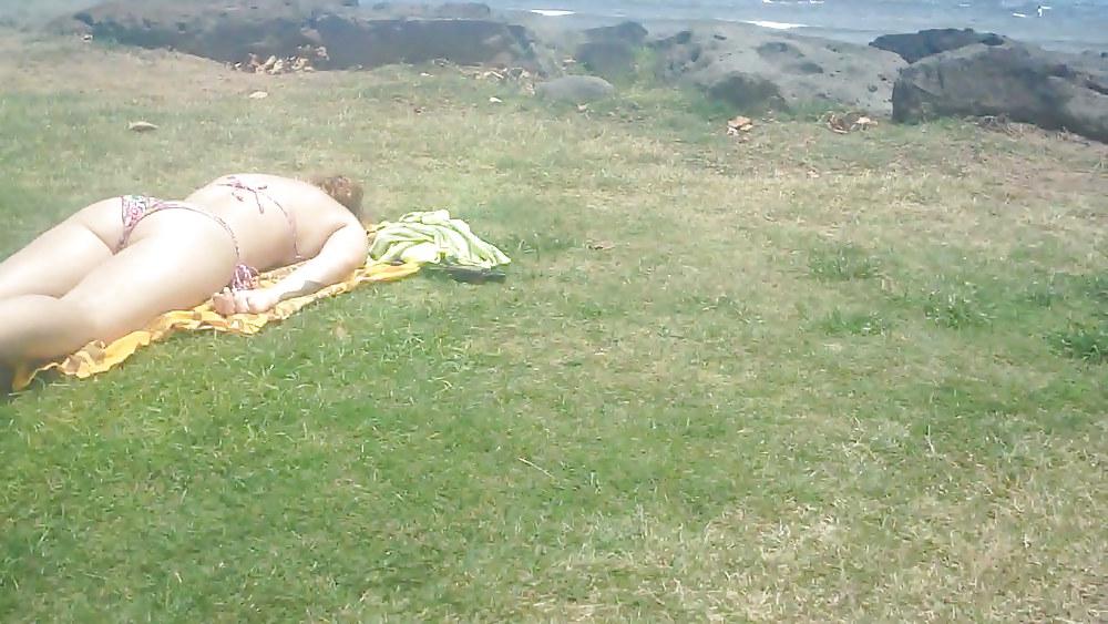 9P Laying with her ass & butt in a field of grass