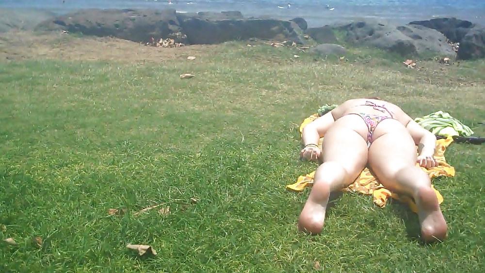 9P Laying with her ass & butt in a field of grass