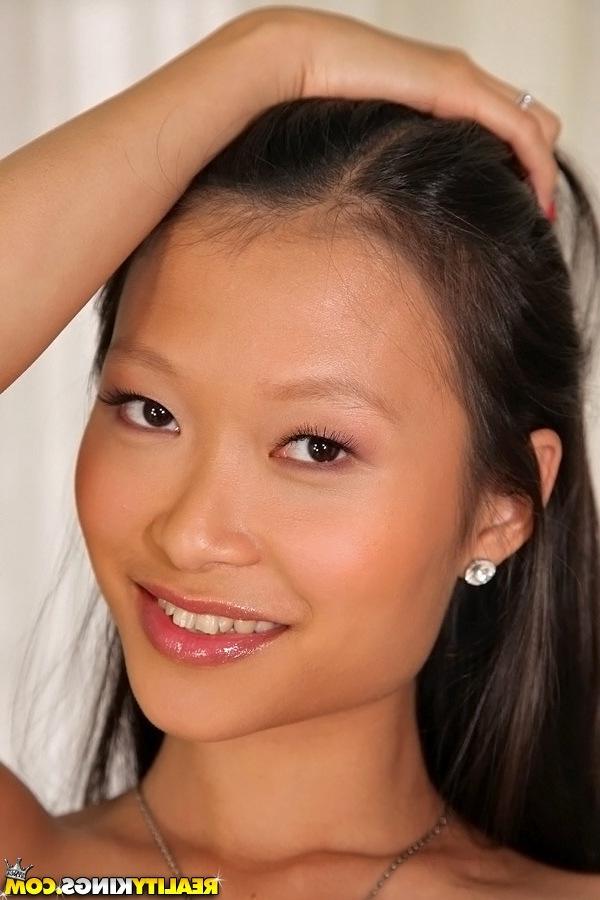 16P Slippy asian sweetie with round bosoms undressing and posing on the bed