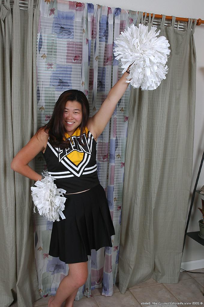16P Asian amateur strips off cheerleader uniform before spreading pussy lips
