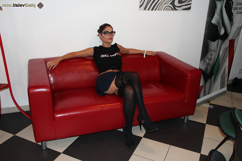 16P Nerdy chick Chiara posing fully clothed on couch in stockings and glasses