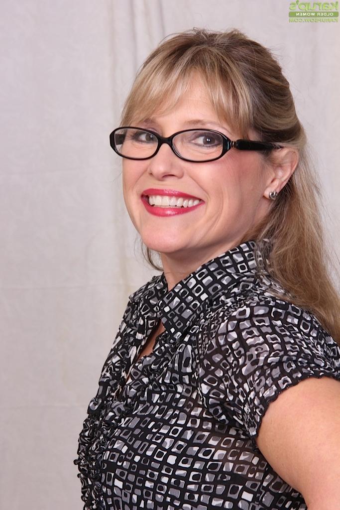 16P Older lady Rebecca Hill unveiling small tits in glasses and leather skirt