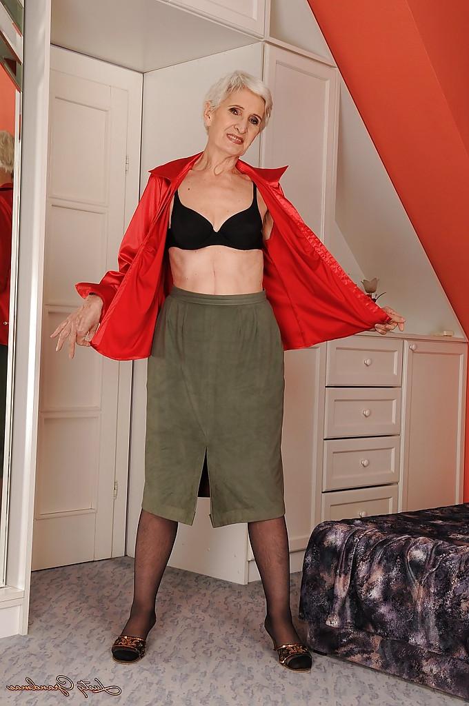 16P Well toned granny in nylon stockings slipping off her clothes