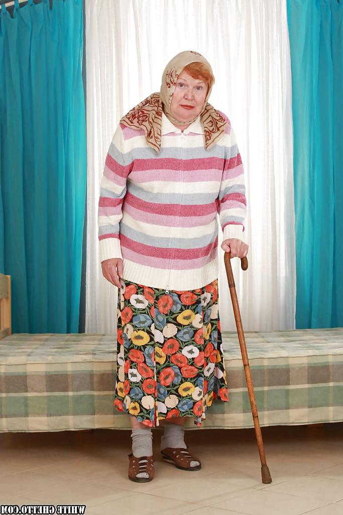 14P Filthy fatty granny with flabby tits stripping and spreading her legs