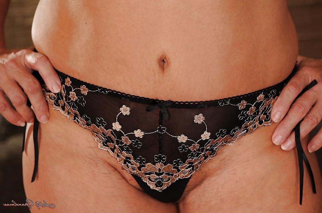16P Naughty granny in glasses undressing and spreading her legs