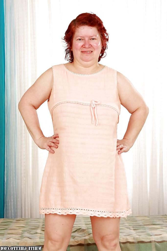 16P Fatty redhead granny with massive jugs stripping off her clothes