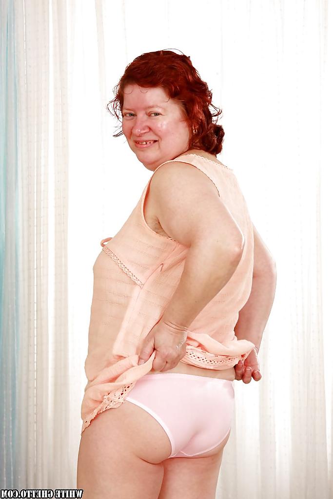 16P Fatty redhead granny with massive jugs stripping off her clothes