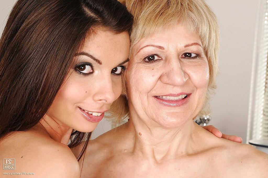 16P Lusty granny with tiny tits poses naked with her teen lesbo babe