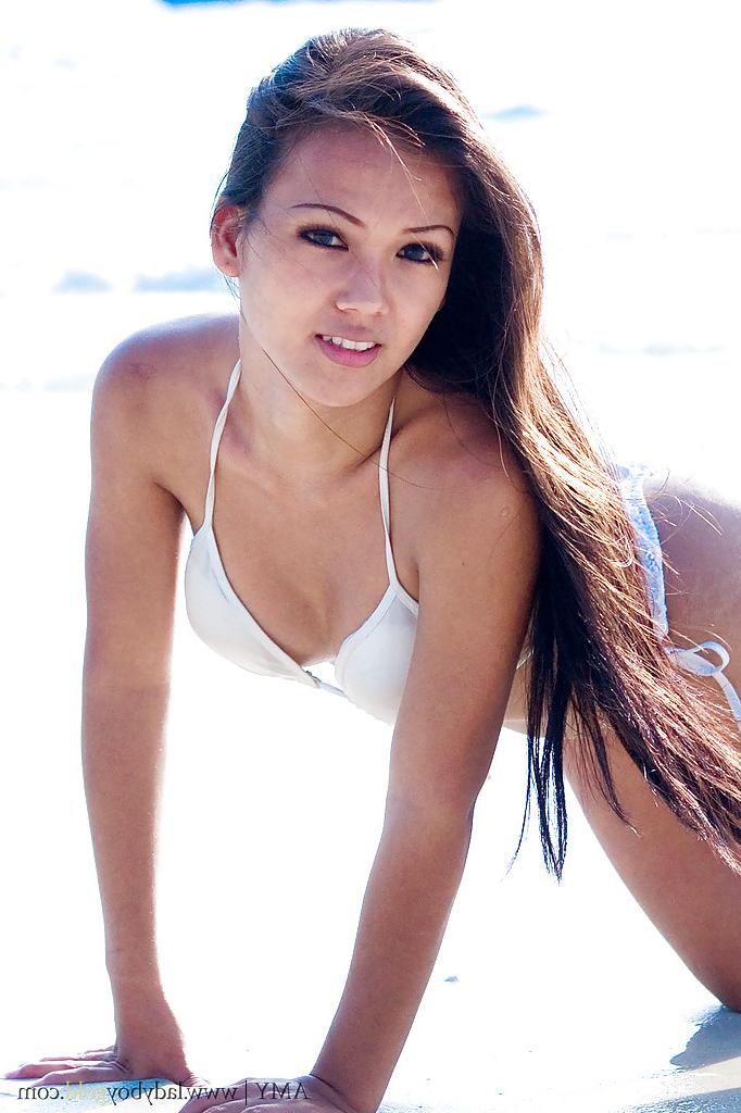 16P Beautiful ladyboy Amy poses in skimpy bikini on beach outdoors