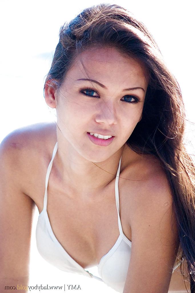 16P Beautiful ladyboy Amy poses in skimpy bikini on beach outdoors