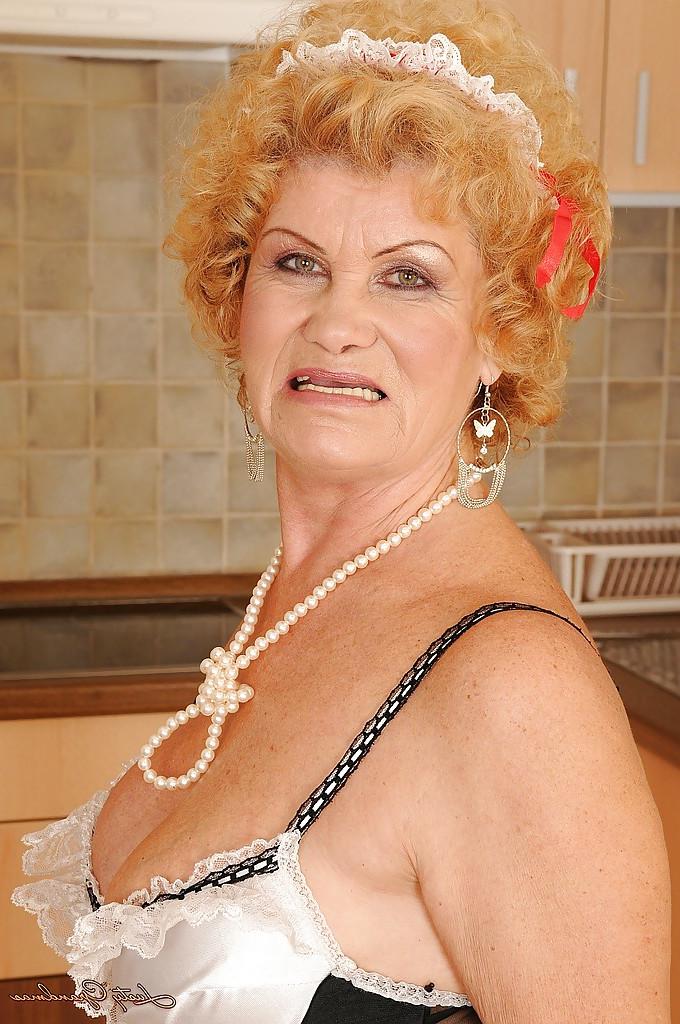 16P Lusty granny in maid uniform and stockings stripping in the kitchen